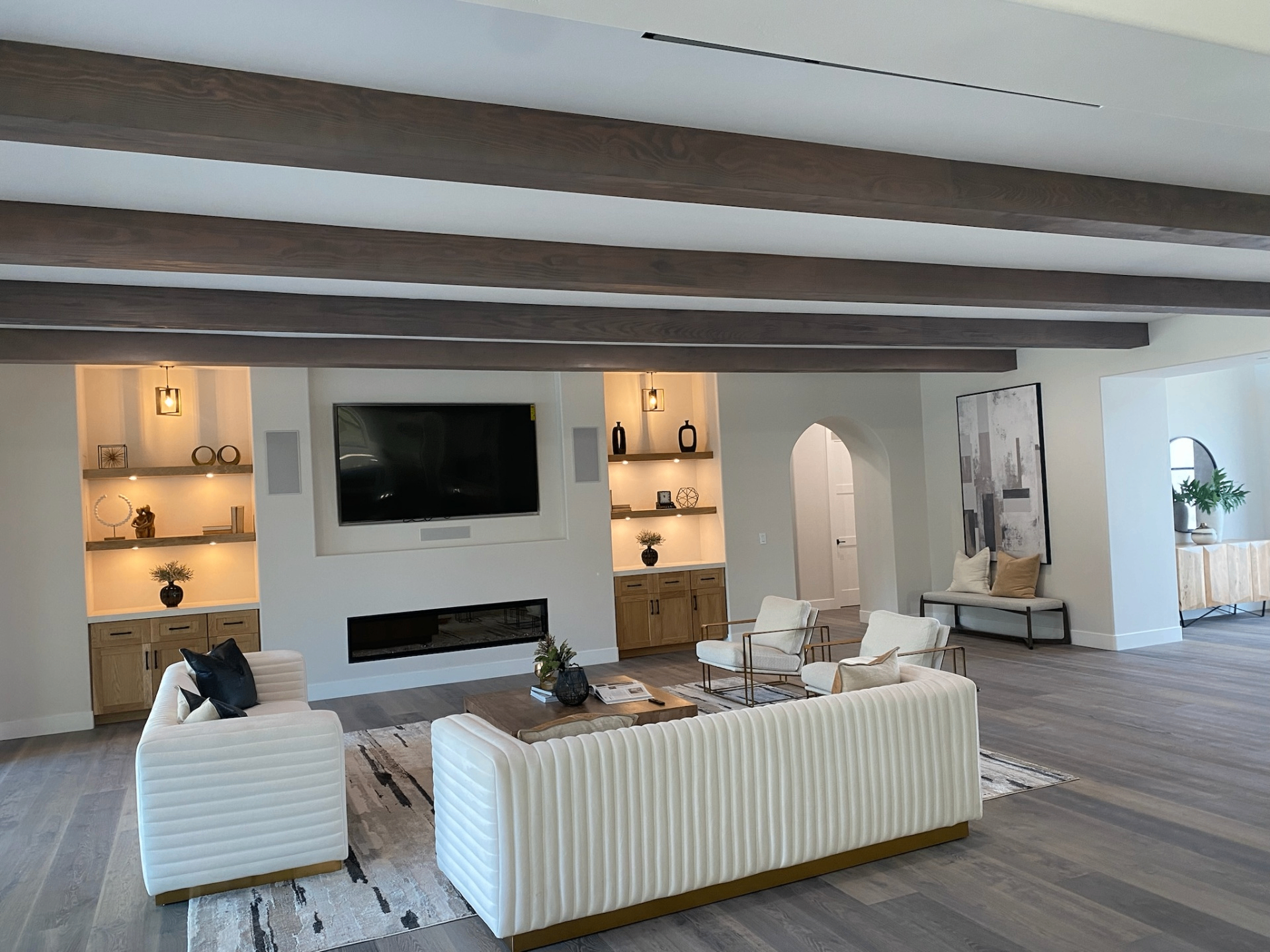 Beautiful interior living room with wooden ceiling beams and custom built-in cabinets